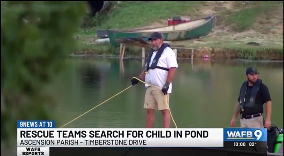 Clint assisting with a child rescue, covered by WAFB